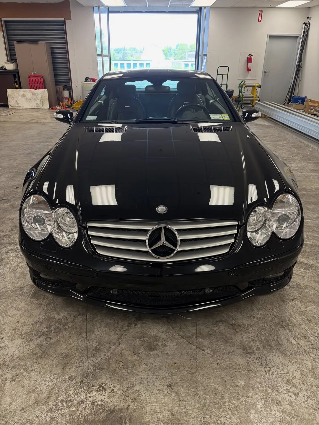 A black Mercedes SL, seen from the front