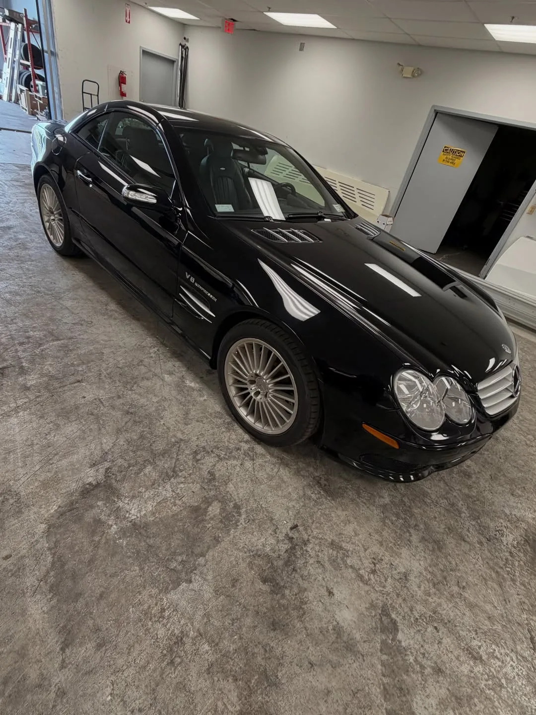 The same black Mercedes SL, seen from above its front corner